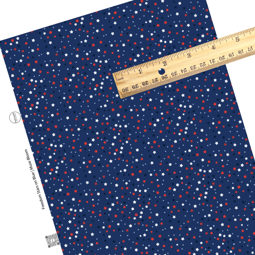 Scattered navy, white, blue, and red stars on navy faux leather sheets