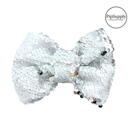 Iridescent reversible white and silver sequin bow
