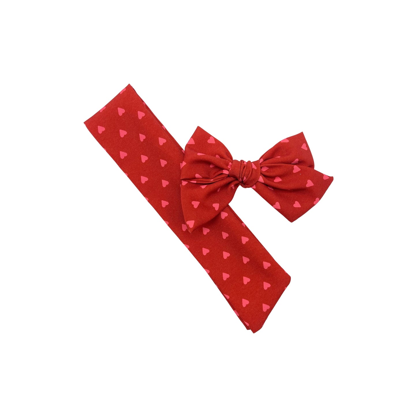 Tied and untied red Ruth style fabric bow strip with pink heart pattern.