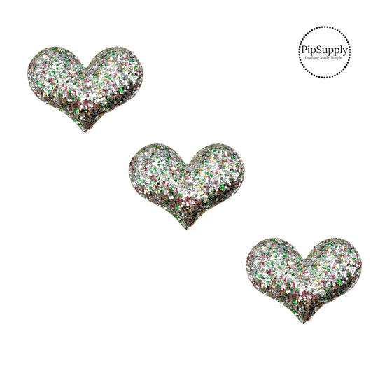 silver glitter padded hearts with multi colored flecks and about two inches wide with fabric backing
