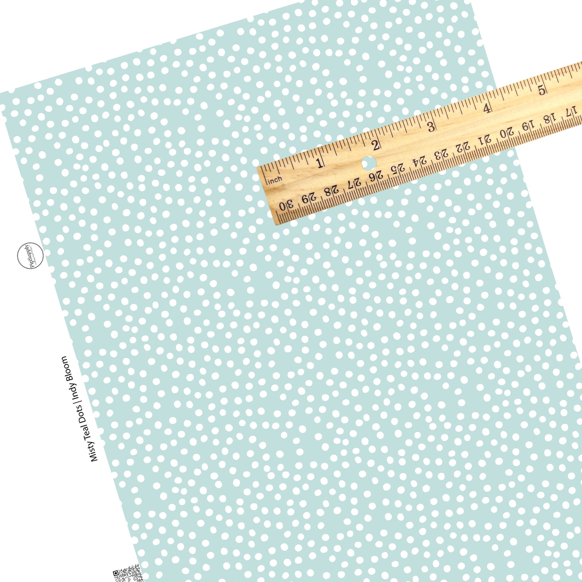 These small dots on a light teal faux leather sheets contain the following design elements: small dots in white scattered on a teal blue background. 