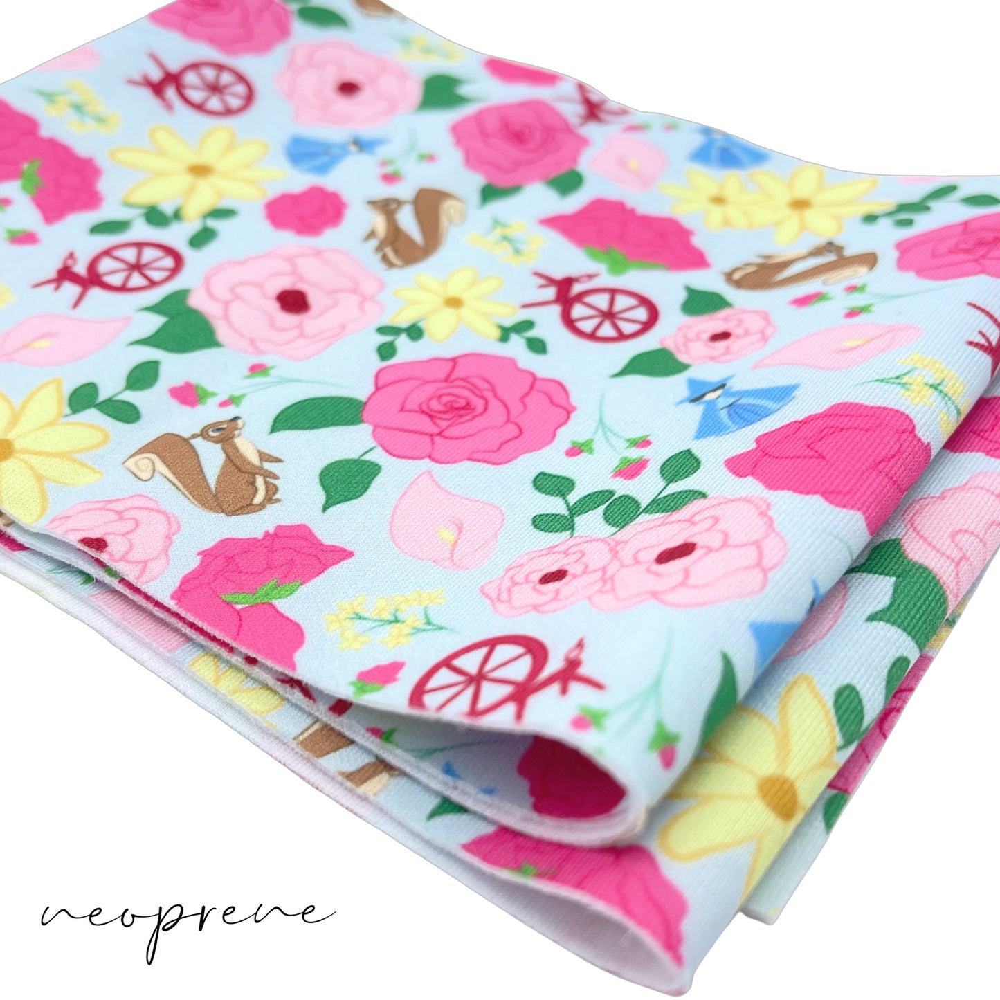 Light blue neoprene fabric with hot pink, light pink, and yellow floral princess pattern including squirrels, blue fairy, and spinning wheels.