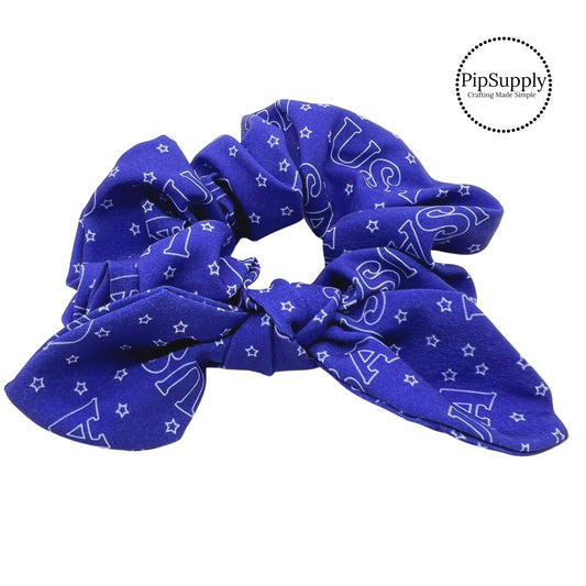 Block letters USA and tiny stars on blue bow scrunchie