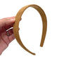 Hand holding tan brown carmel suede velvet lined headband.