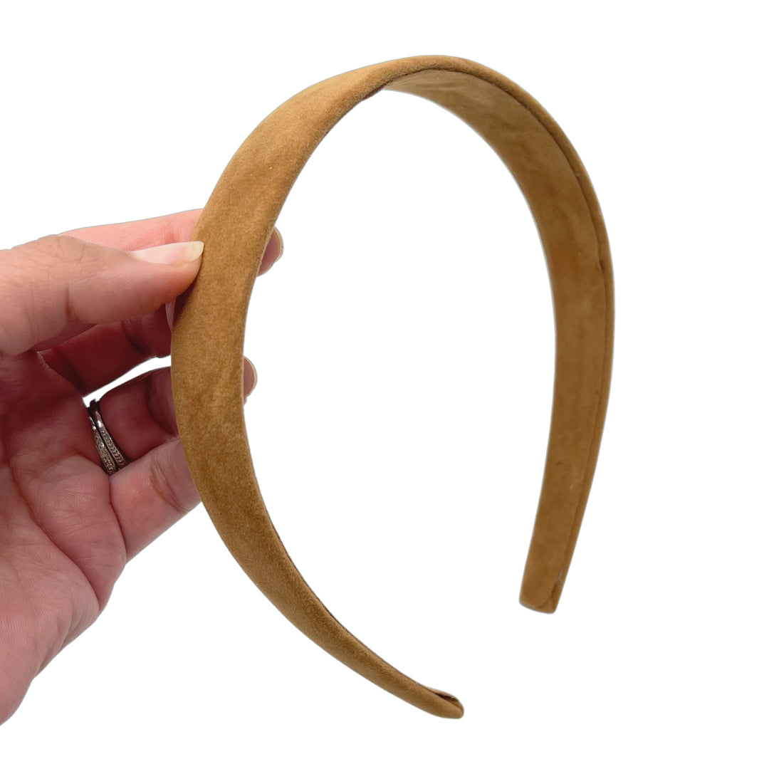 Hand holding tan brown carmel suede velvet lined headband.