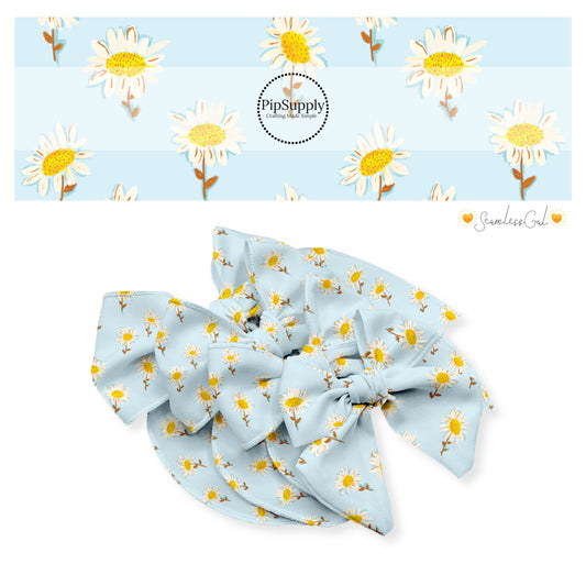 White daisy with yellow center on blue bow strips