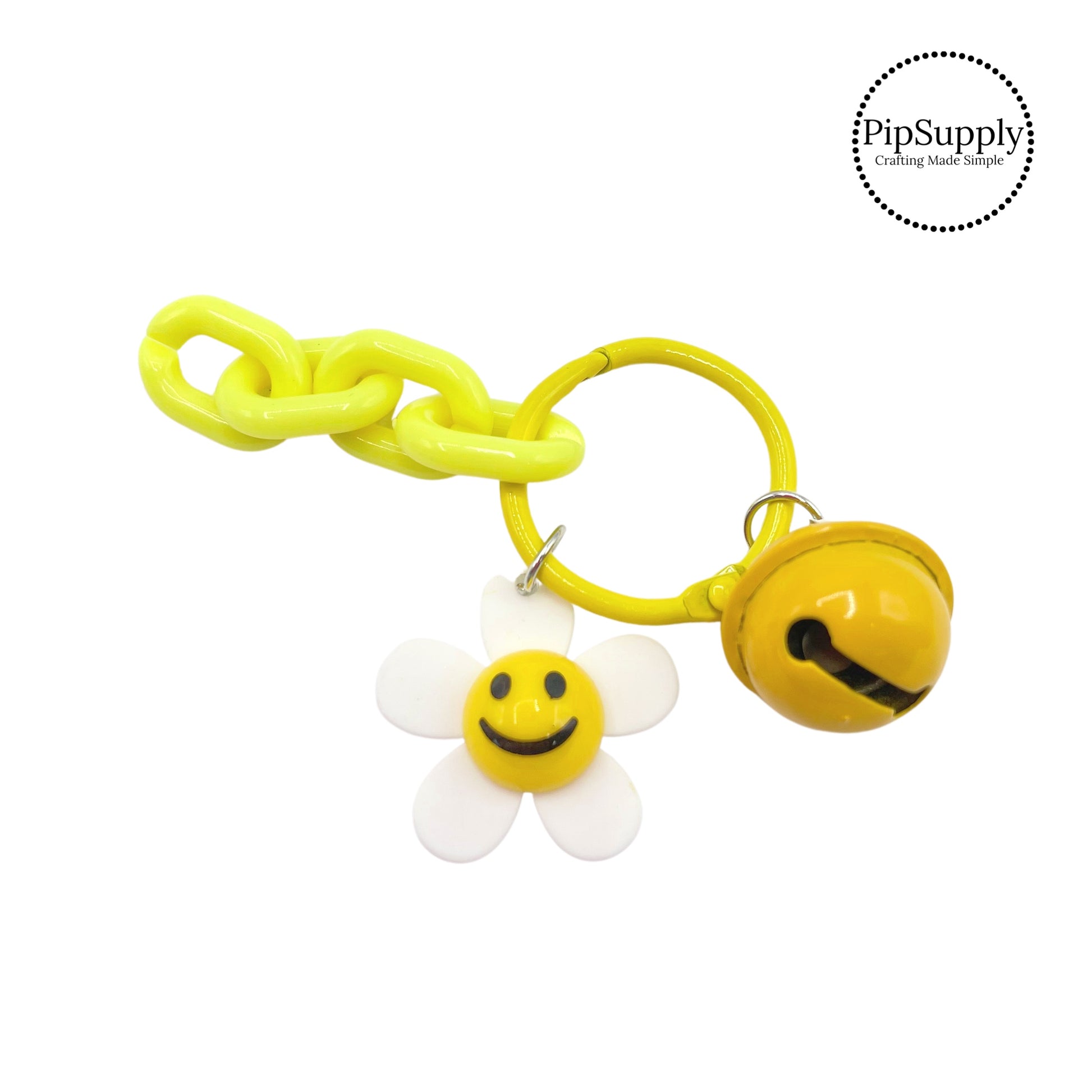 White flower with smiley face on yellow keychain 